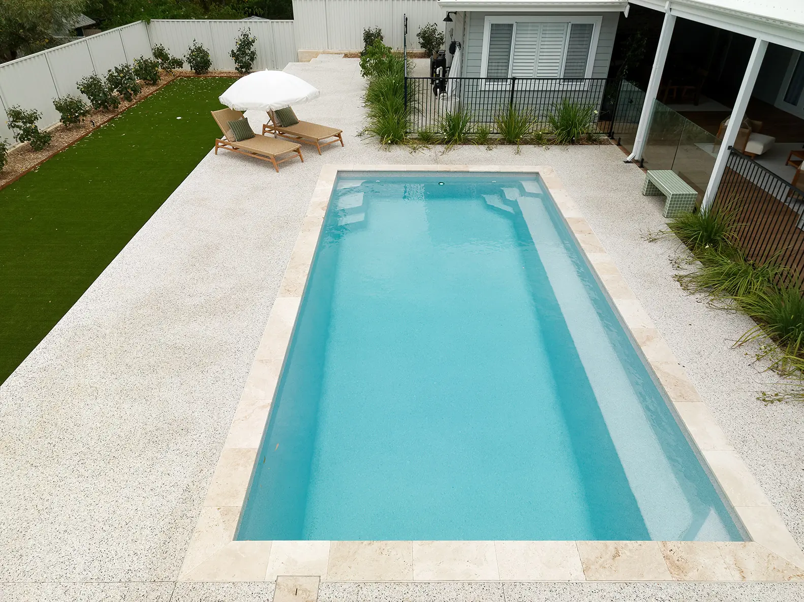 Aerial view of a Freedom Pools Entertainer 8 fibreglass pool and paving
