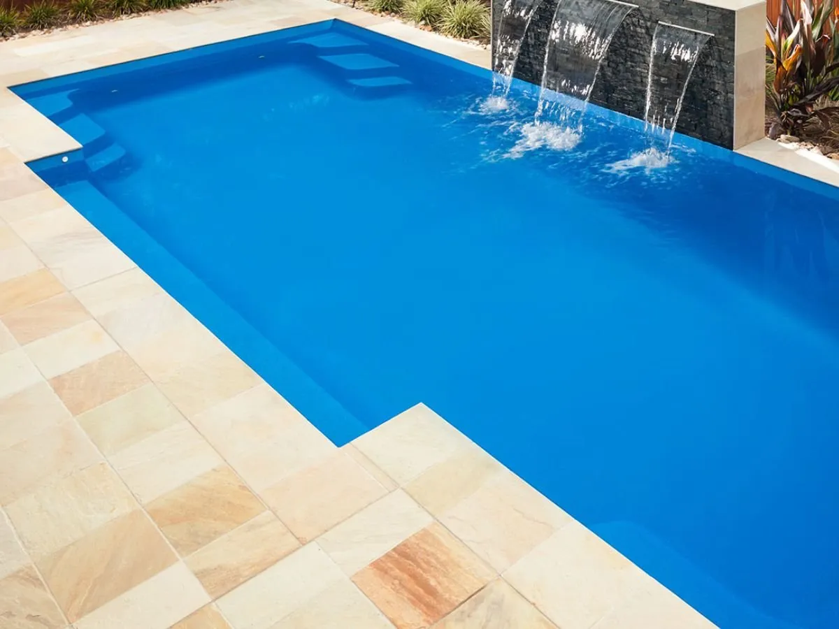 Ambassador 6m fibreglass pool showing entry steps and water feature