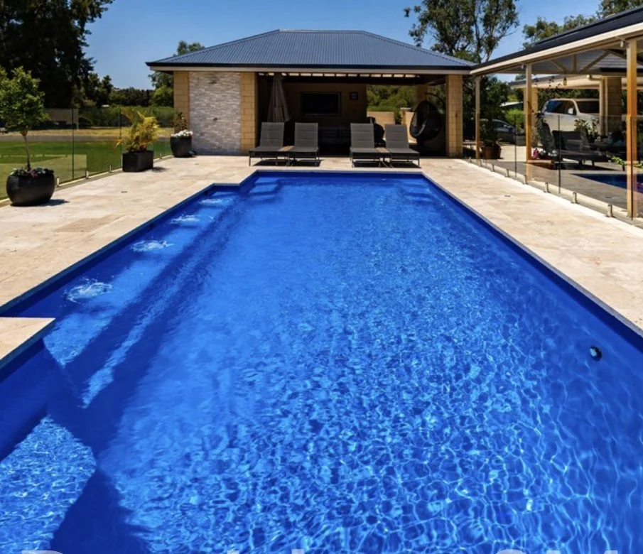 President 9m fibreglass pool with clean lines, paved surrounds and poolside loungers
