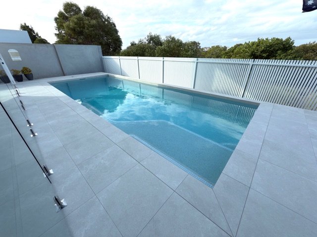 Modern pool with glass fencing